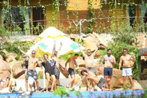 a group of men standing around a swimming pool at Dendi Resort Phu Quoc in Phú Quốc