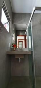 a bathroom with a sink and a mirror at Agapanthus Apartamentos in Jericoacoara