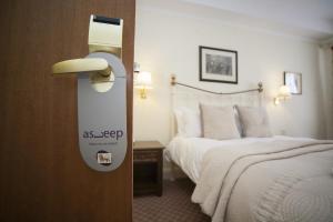 a hotel room with a bed and a sign on the door at The Lion Hotel Shrewsbury in Shrewsbury
