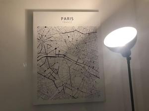 a book with a lamp and a picture of a city at *Le Yellow -Appartement T2, hypercentre* in Limoges