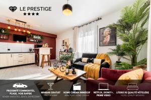 a living room with a couch and a table at Le Prestige* * * * - Minibar Gratuit - Parking in Saint-Pierre