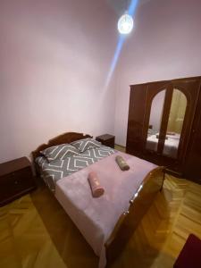 a bedroom with a bed and a light on the wall at House 1891 in Kutaisi