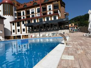 a large swimming pool in front of a building at Apartman Ena Fojnica in Fojnica