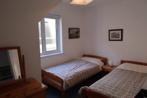 a bedroom with two beds and a window at Obsidian: Arguably the best view in Portballintrae in Portballintrae