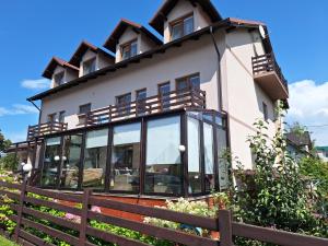 a house with a fence in front of it at Omega Jantar in Jantar