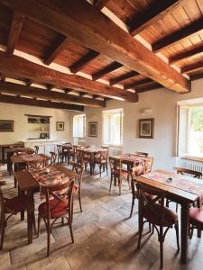 a dining room with wooden tables and chairs at L'Antico Asilo in Stazzema