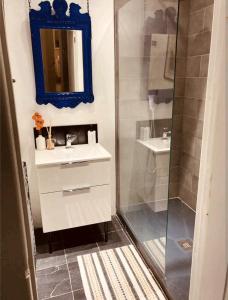 a bathroom with a shower and a sink and a mirror at One The Mews in Glasgow