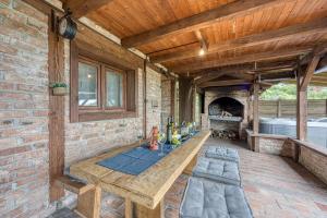 an outdoor patio with a table and a fireplace at Holiday Home Primus in Jastrebarsko