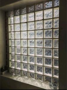 a glass block window with a picture of mountains at One The Mews in Glasgow