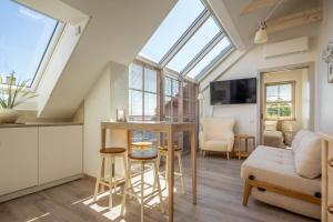 a loft conversions kitchen and living room with a skylight at Nauji apartamentai! Pamario 14 in Nida