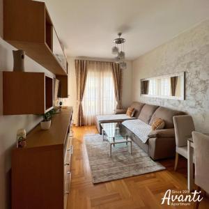 a living room with a couch and a table at Apartmani Avanti Budva in Budva