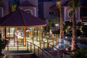 a playground with a gazebo and palm trees at night at Meral Oasis Resort Taif in Taif