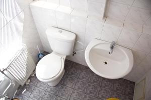 a bathroom with a toilet and a sink at Penzión Alberto in Prievidza +33 photos