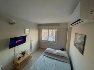 a small room with a bed and a window at Acropolis Panorama Studio in Athens