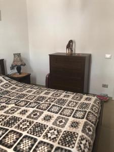 a bedroom with a bed with a black and white quilt at Bouganvilla in Adeje +11 photos