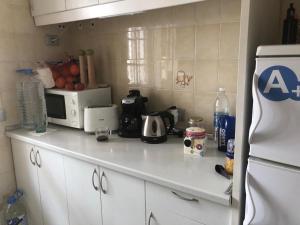 a kitchen with a white counter top with a microwave at Bouganvilla in Adeje