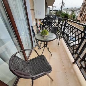 a balcony with a table and chairs on it at Holiday apartment Kobuleti in K'obulet'i