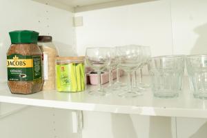 a shelf with wine glasses and spices on it at Lily Studio Apart *Top location* in Jerusalem