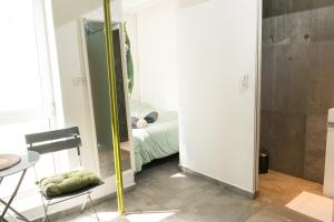 a small room with a bed and a mirror at Lily Studio Apart *Top location* in Jerusalem