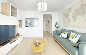 a living room with a blue couch and a tv at 1 Bedroom Nice Apartment In Cullera in Cullera