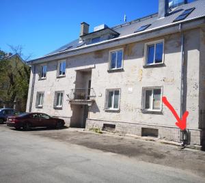 a building with a red arrow on the side of it at Revalia Airport-Bus station Studio in Tallinn