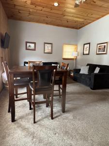 a living room with a table and chairs and a couch at Stay In Ohiopyle - closest place to the GAP trail in Ohiopyle, PA in Farmington