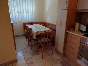 a kitchen with a table and chairs in a kitchen at Apartment 4 Kullat in Prizren