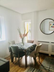 a dining room with a table with chairs and a mirror at City location- 2 bedroom apartment in London