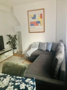 a living room with a couch and a television at City location- 2 bedroom apartment in London