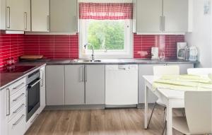 a kitchen with white cabinets and red tiles at Beautiful Home In Sjernary With House Sea View in Nedstrand