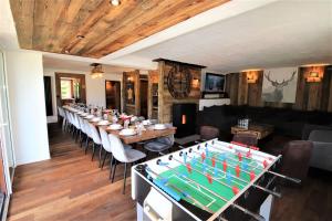 a large dining room with a large table with a billiards at Chalet le Chantelevent for 24 Guests - Slope Views, Pool & Jacuzzi in Vars