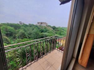 a room with a balcony with a view of trees at Private 1-Bedroom Apartment in Rawalpindi