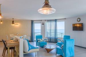 a living room with blue chairs and a table at Castello Mare All Inclusive Resort in Batumi