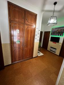 a large wooden cabinet in a room with at Pilar Hostel - Rua de Santa Catarina - Porto in Porto