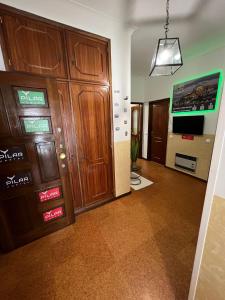 a living room with wooden cabinets and a tv at Pilar Hostel - Rua de Santa Catarina - Porto in Porto