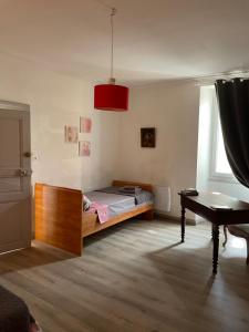 a bedroom with a bed and a desk in it at Résidence du bord du Tarn in Millau