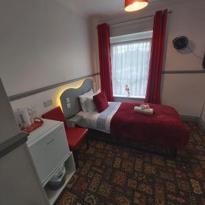 a hotel room with a bed and a window at St Albans Guest House, Dover in Dover