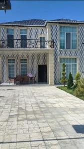 a large house with a patio in front of it at Luxury Millionere villa in Gabala