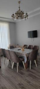 uma sala de jantar com uma mesa e cadeiras e um lustre em Luxury Millionere villa em Gabala
