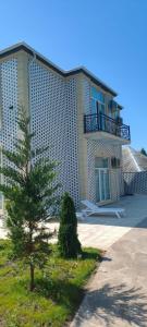 a large building with a tree in front of it at Luxury Millionere villa in Gabala