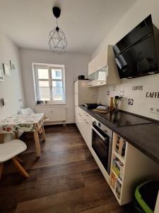 a kitchen with a table and a counter top at Fewo Am Marktplatz II in Eisenhüttenstadt