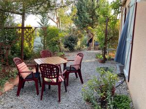 a table and four chairs and a table and a person at Maison Bon Ton in Paraza +19 photos