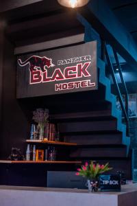 a sign for a black hospital on the wall at Black Panther Hostel in Phuket