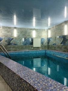 a large swimming pool in a building at Villa5floors in Chişinău