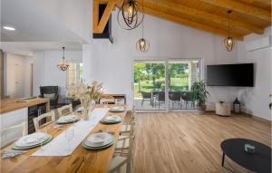 a dining room and living room with a table and chairs at 3 Bedroom Cozy Home In Buje in Buje