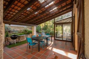 a patio with a table and chairs on a patio at La Champanel Maison vue Mer JO24 in Marseille