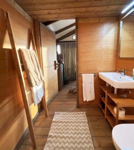 a bathroom with a sink and a toilet and a mirror at Glamping - Il Giardino di San Giorgio in Montorgiali