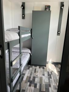a room with two bunk beds and a door at Chalet Espagne EL FARO 4/6p in Camarles