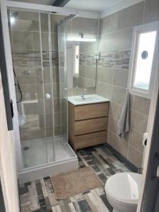 a bathroom with a shower and a toilet and a sink at Chalet Espagne EL FARO 4/6p in Camarles