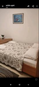 a bed in a bedroom with a picture on the wall at Apartments Mar in Ulcinj